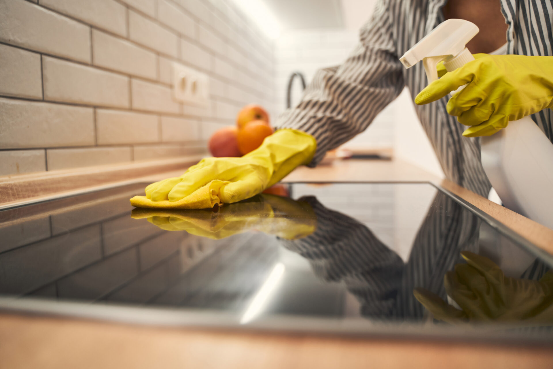 Close up of female hand that cleaning oven